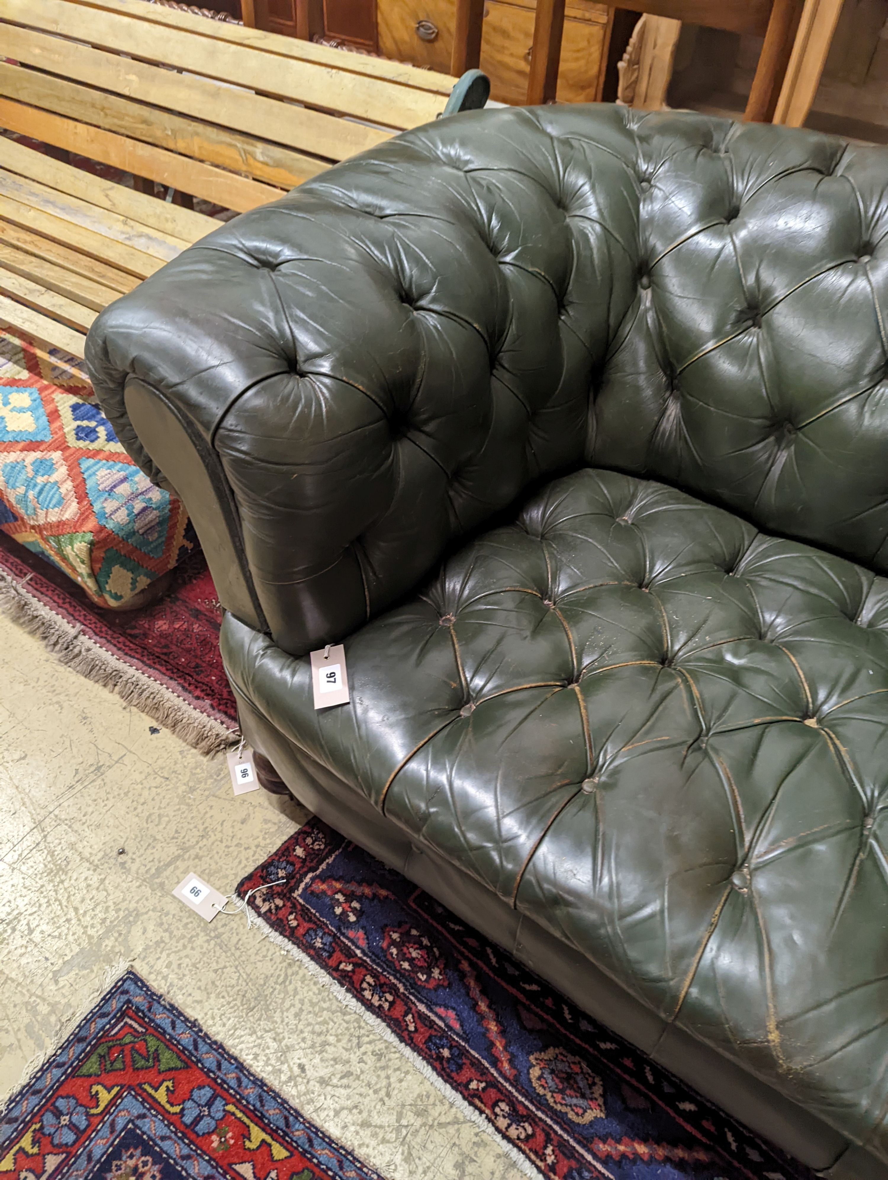 A late Victorian buttoned green leather Chesterfield settee, length 184cm, depth 82cm, height 70cm